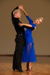 latino dance couple in action  preforming a exhibition dance - wild samba