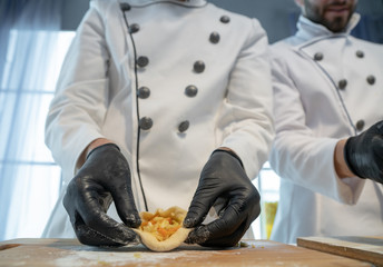 The cook makes pies with cabbage