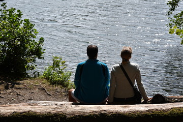 A young couple is resting at a lake in Berlin Germany.