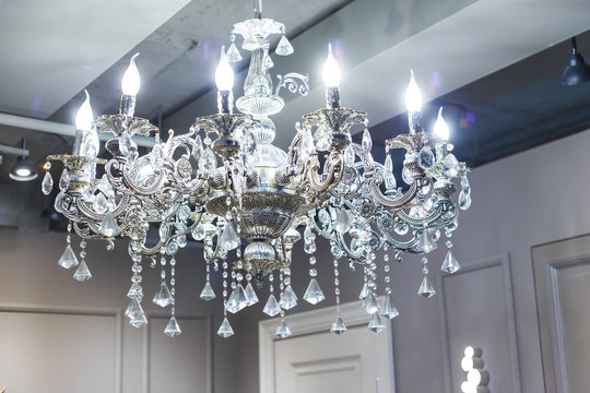 Crystal Chandelier Shines Hanging From The Ceiling In The Room