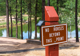 Fototapeta na wymiar No horses sign on trail