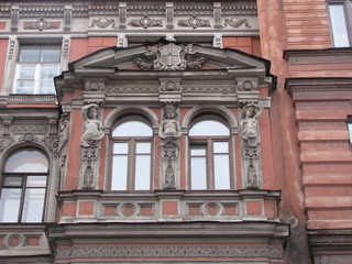 Atlanteans and caryatids as a decoration of the facade of the building