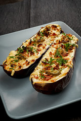 delicious casserole of aubergine cheese and jalapeno peppers on a gray plate