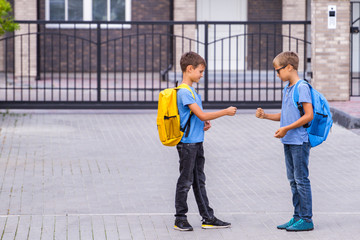 Two boys playing rock paper scissors game after school