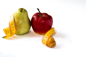 Pear and red apple tied wth centimeter tape isolated on white background.