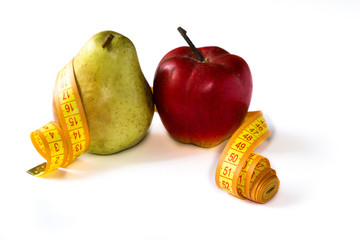 Pear and red apple tied wth centimeter tape isolated on white background.
