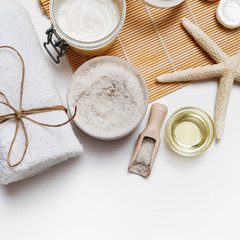 Spa still life. Wellness cosmetic products on white paper background. Flat lay.