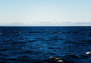 Naklejka premium The sea of Ladoga lake from the boat. Turbulent sea. Ripples and small waves.