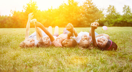 Interracial group of kids as friends in summer