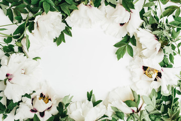 Frame of white peony flowers bouquet on white background. Flat lay, top view mock up.