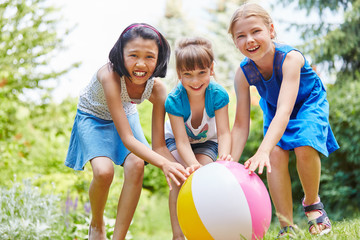 Three children playing ball and having fun