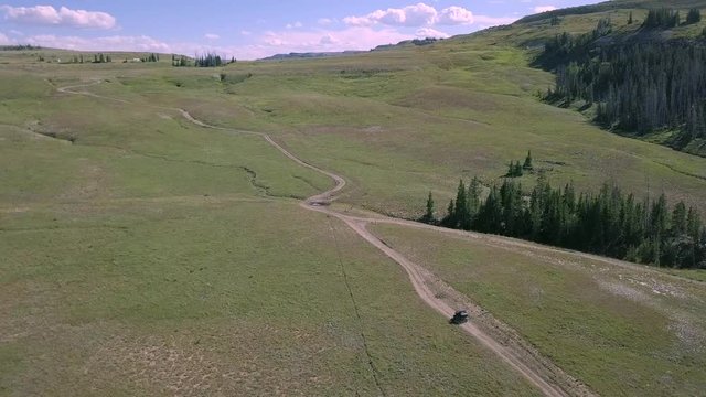 Driving an ATV through a Beautiful mountain meadow 