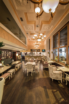 Restaurant interior with antique furniture and big classic chandeliers