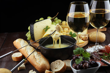 Gourmet Swiss fondue dinner on a winter evening with assorted cheese