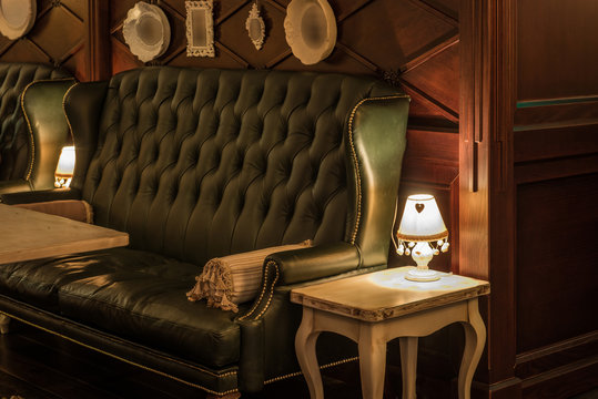 Naklejka Luxury leather sofas and tables in restaurant interior