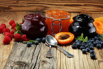 assortment of jams, seasonal berries, apricot, mint and fruits. marmalade or confiture