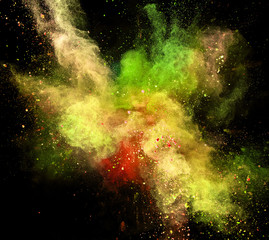 Colored powder explosion on black background.