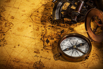 Fototapeta na wymiar Old vintage navigation equipment on old world map.