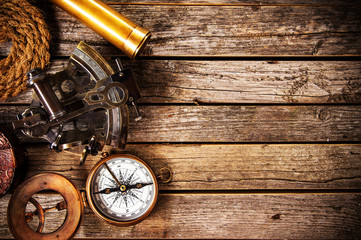 Old vintage navigation equipment on old wooden background.