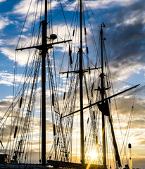 Mast and rope sailboat vessel on sky sunset background