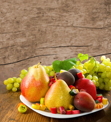 different fruits and sweets on wooden table