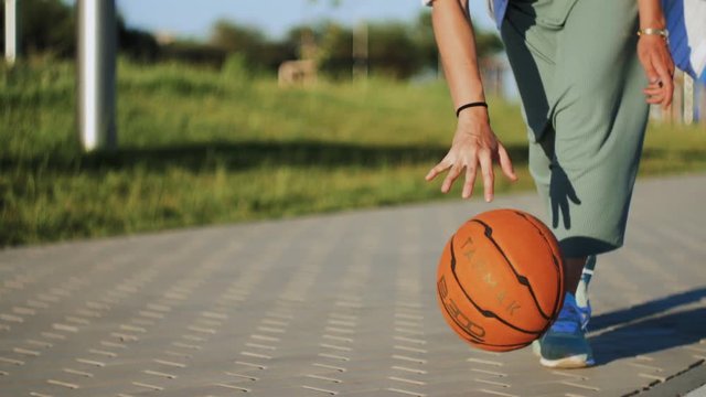Close up of woman is playing basketball