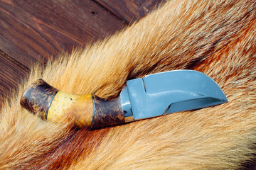 Hunting knife on red fox fur.