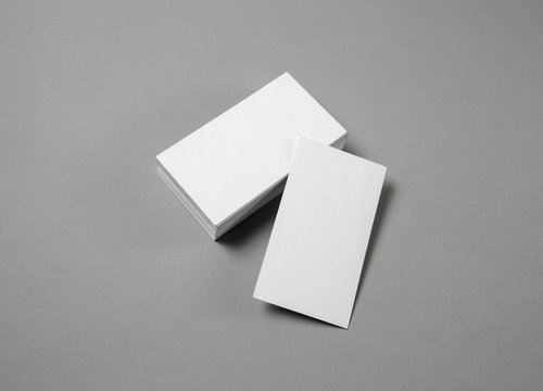 Mockup of blank business cards at gray paper background.