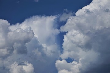 Amazing cumulus clouds and sunlight on the background of clear blue sky, Summer in GA USA.