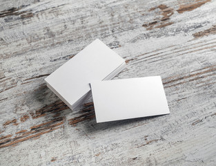Blank white business cards on wood table background. Mockup for branding identity.