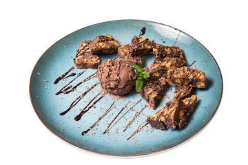 chocolate brownie and ice cream on a plate isolated on a white background