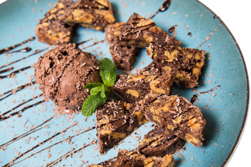 chocolate brownie and ice cream on a plate isolated on a white background