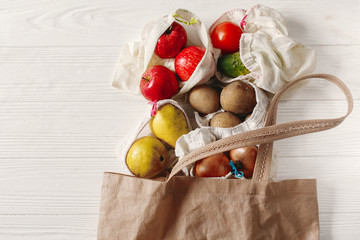 zero waste food shopping. eco natural bags with fruits and vegetables in tote, eco friendly, flat...