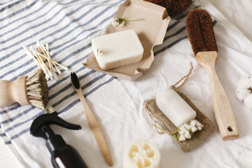 Fototapeta na wymiar natural eco luffa, bamboo toothbrush, brush, coconut soap, handmade detergent and crystal deodorant on towel, bathroom essentials. sustainable lifestyle concept, zero waste