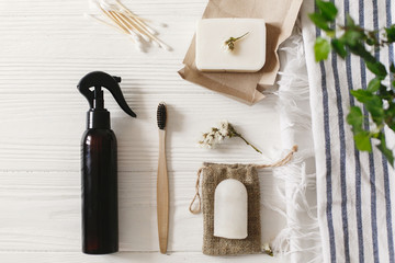 sustainable lifestyle. zero waste concept. natural eco bamboo toothbrush, coconut soap, handmade detergent, crystal deodorant, bamboo ear sticks on towel, bathroom essentials