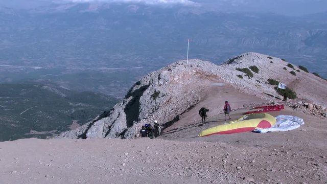 People are preparing for paragliding on Babadag mountain in Turkey. Amazing nature, beautiful scenery and magnificent landscape of the resort of Oludeniz.