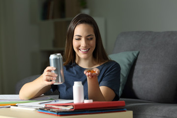 Fototapeta premium Happy student with energy drink and vitamin pills
