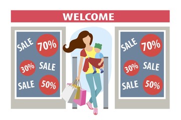 a young mother comes out of the store with a baby in her arms