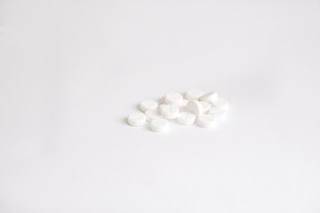 Fototapeta na wymiar white pills on white background (warm toned)