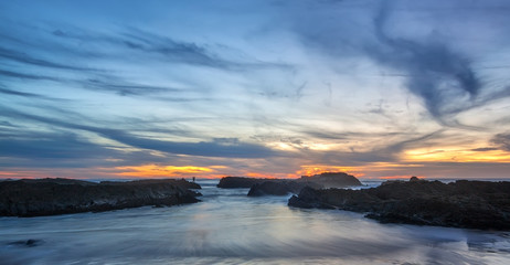 Magic sunset on the Portuguese coast, with the figure of a woman in the background.
