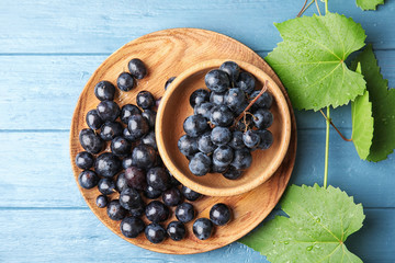 Flat lay composition with fresh ripe juicy grapes on wooden background