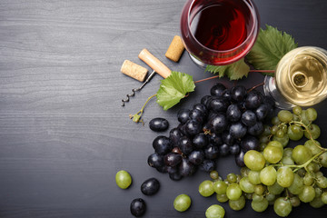 Flat lay composition with fresh ripe juicy grapes and space for text on wooden background