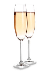 Glasses of rose champagne on white background. Festive drink