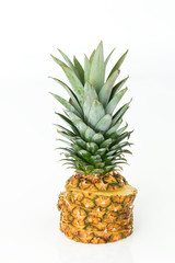 Pineapple cut into pieces piled up, on a white background.