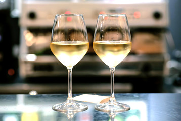 Two wine glasses in bar. Date time for loving people inside restaurant or cafe