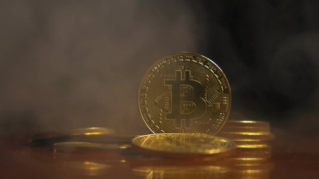 gold coins, bitkoyny on the background of a smokescreen in the light of safitov. close-up. Crypto currency. Virtual currency, 4k