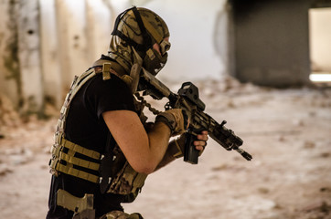 Airsoft soldier with mask protection inside building