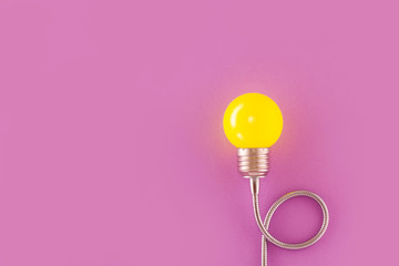 One yellow decorative lamp on a light violet background.