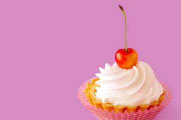 A bright ripe cherry berry on the top of a delicious cake.