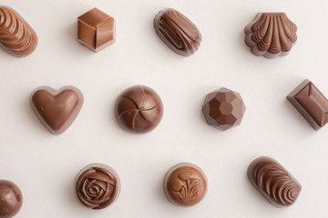 Filled Chocolate, sweets seen from above with white background and smooth lightning